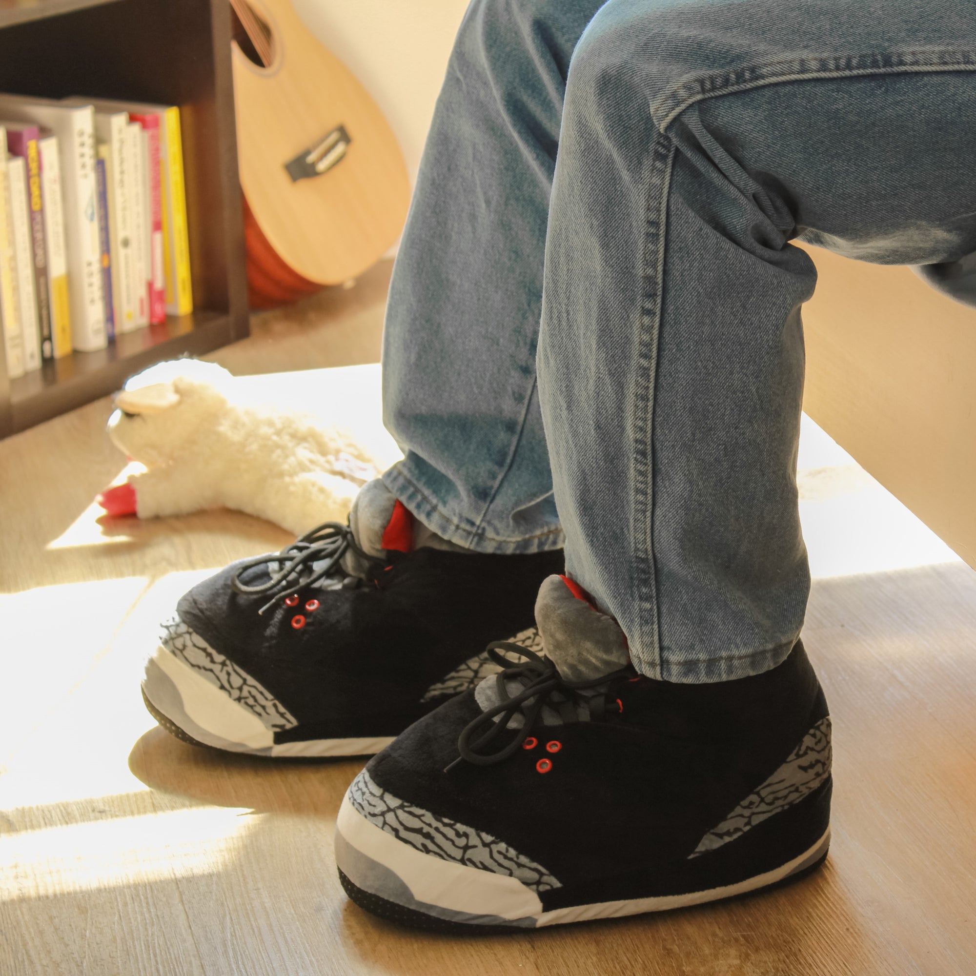 Model wearing Yours 2 Keep Black Marble Sneaker Slippers next to a bed