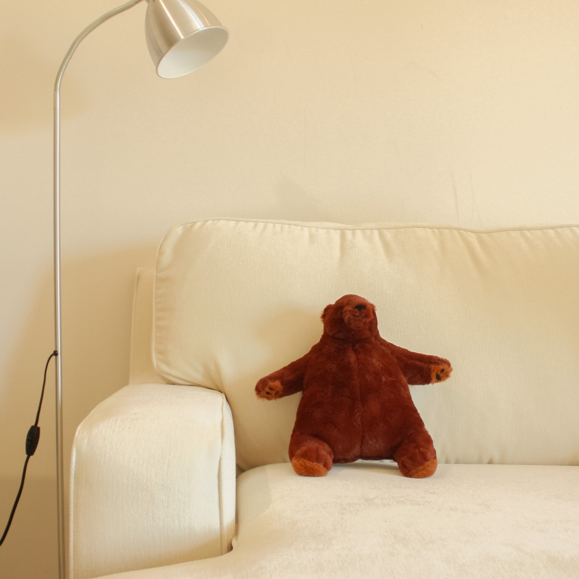 Yours 2 Keep Sleepy Bear sitting on couch with lamp